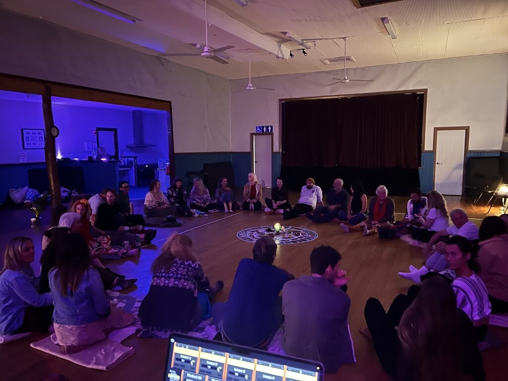 Participants seated together in a community listening circle during a Soundful Experience