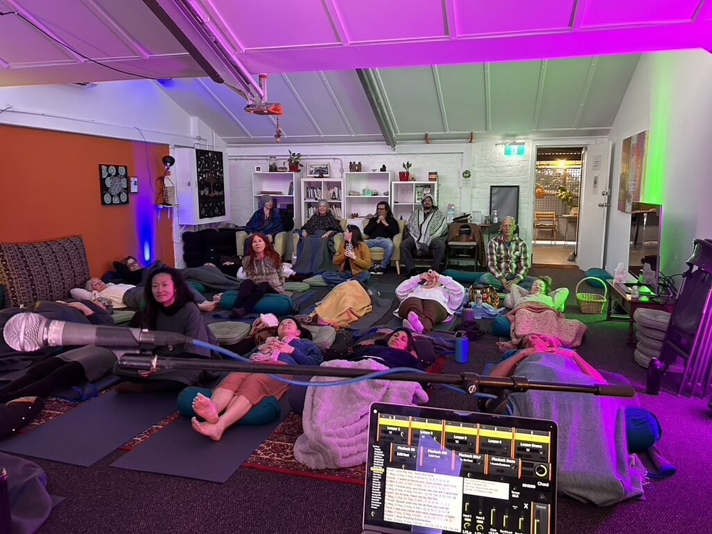 Community group gathered in a coloured light venue for a live Soundful Experience